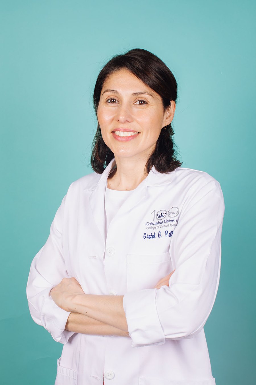 Dr. Gretel Pellegrini, periodontist and bone biologist, in a white coat